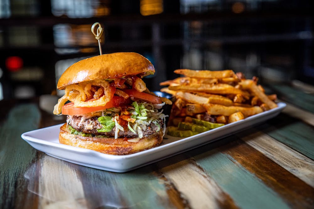 <p>A burger and fries from Bru Burger is seen. Bru Burger Bar will open in Bloomington on the corner of Third and Grant Street by early 2024.</p>