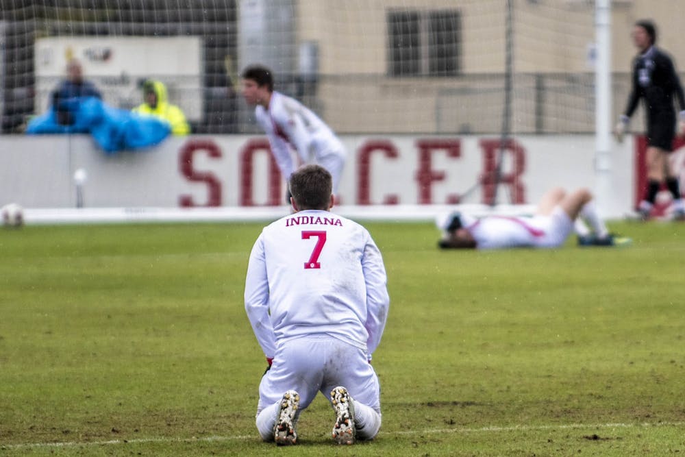 <p>Freshman Victor Bezerra rests on his knees after IU was eliminated from the NCAA Tournament by the University of California, Santa Barbara on Dec. 1 at Bill Armstrong Stadium. UCSB slotted the ball past freshman IU goalkeeper Roman Celentano in the second period of overtime.</p>