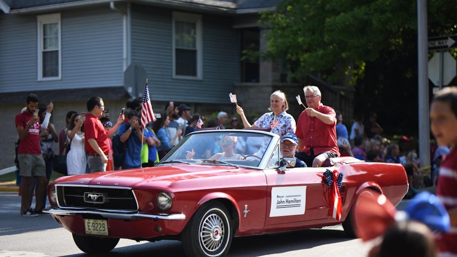 Bloomington’s mayor John Hamilton and his wife start the 4th of July parade on Tuesday. The parade attracted hundreds of visitors to sit and watch different floats parade downtown.