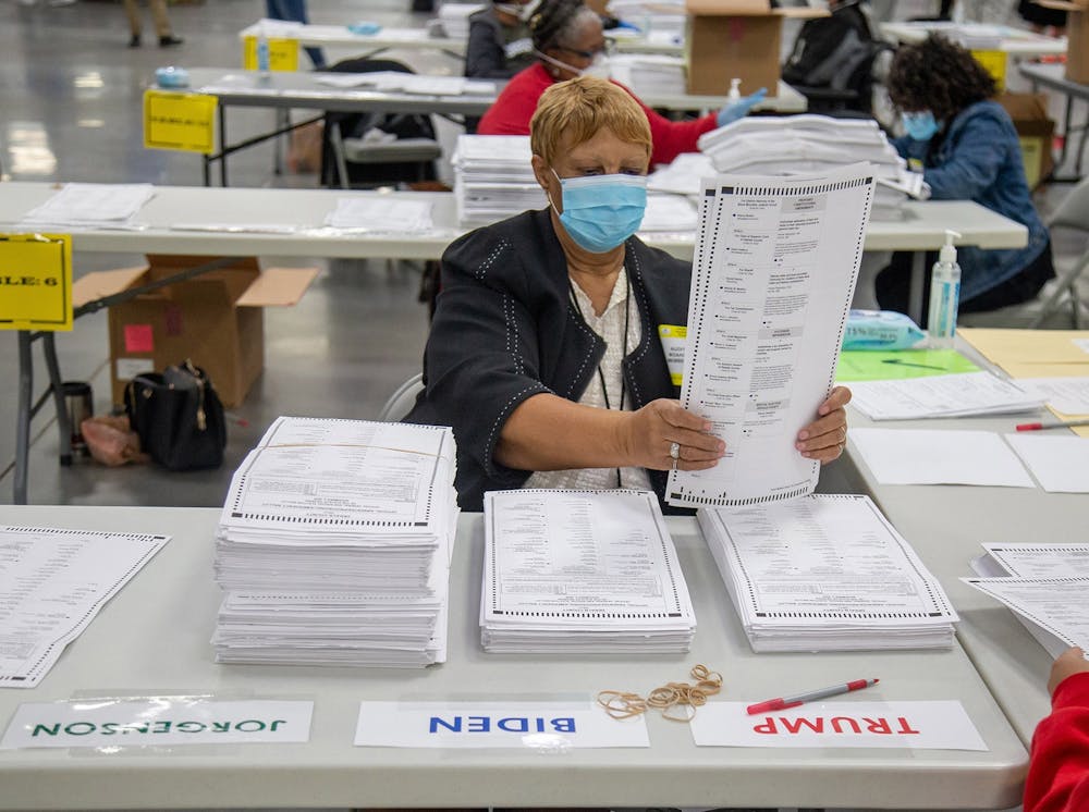 <p>An election worker counts presidential ballots Nov. 14, 2020, in Dekalb County, Georgia. Four Indiana political candidates have denied the results of the 2020 presidential election.</p>