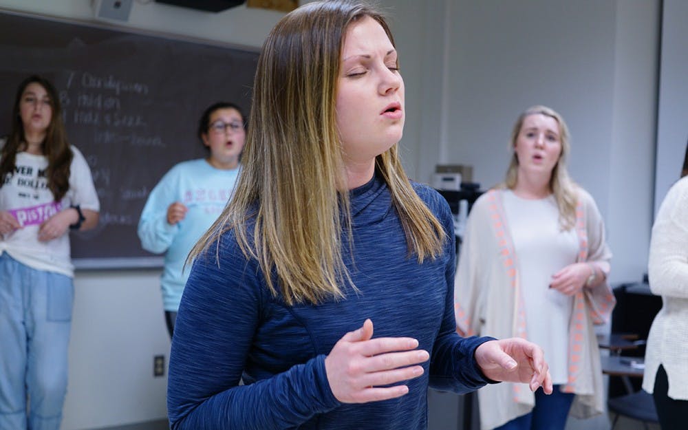 IU senior Abby Penland practices for her senior solo for the Ladies First Acapella group's performance on Friday.