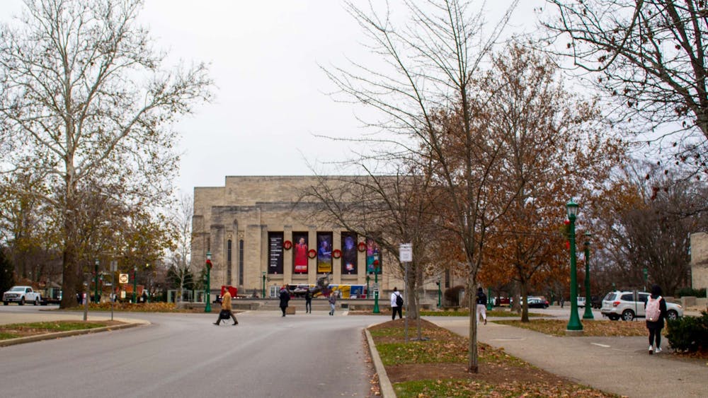 Students walk on Dec. 7, 2021, along East Seventh Street in front of the IU Auditorium. An IU survey released by the university shows high amounts of substance and mental health issues among students.
