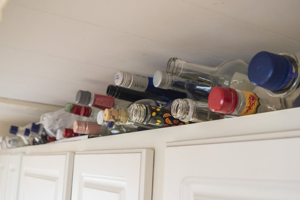 <p>Various alcohol bottles rest on a “kill shelf” Sept. 26 in a kitchen. The IU Police Department shut down three parties late Saturday night because party goers did not follow the  Gov. Eric Holcomb’s stay-at-home order.</p>