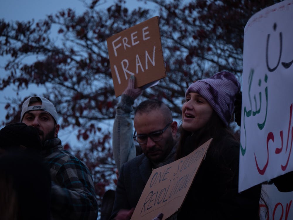 A demonstrator joins in a chant Nov. 16, 2022, outside of the Monroe County Courthouse. Chants were raised by organizers from the Iran Midwest Solidarity Group between speeches and included mantras, such as &quot;Hey, ho, the Islamic regime has got to go&quot; and &quot;Women, life, freedom.&quot;