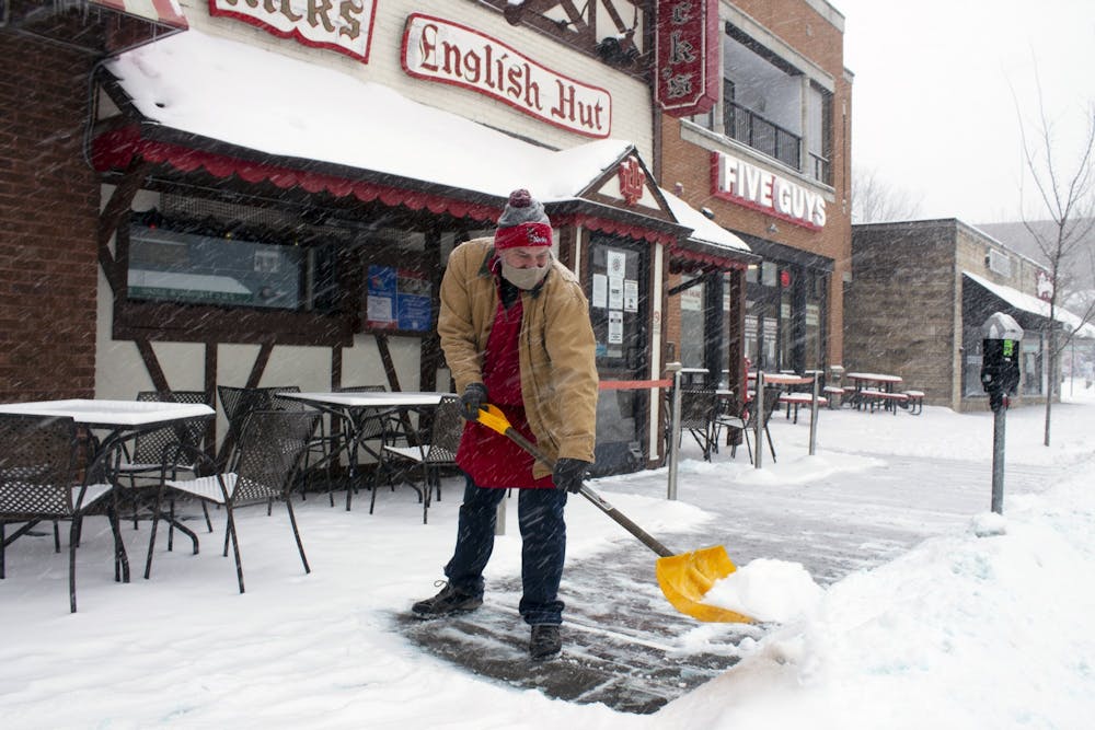 <p>Nick&#x27;s English Hut General Manager Pete Mikolaitis shovels snow from the sidewalk Monday on Kirkwood Avenue. Bloomington is expected to receive as much as a foot of snow between Monday afternoon and Tuesday morning. </p>