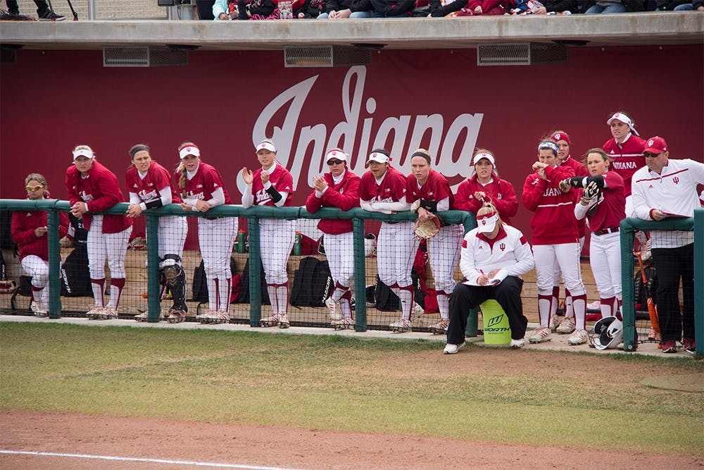 Members of IU Softball team watch the game against #2 ranked University of Michigan at Andy Mohr Field last Saturday. The Hoosiers lost 0-8.