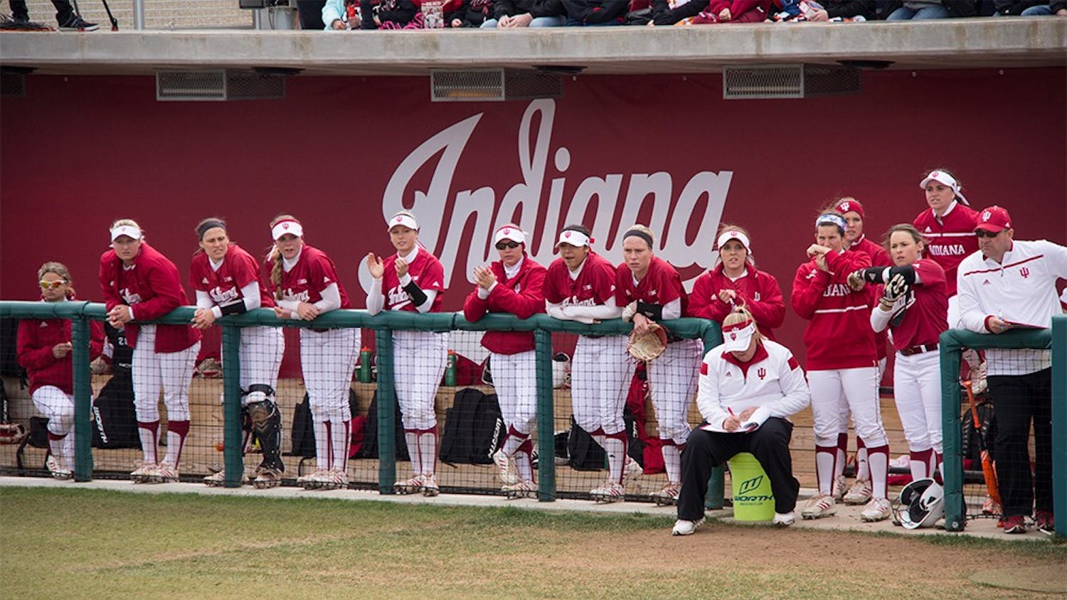 Members of IU Softball team watch the game against #2 ranked University of Michigan at Andy Mohr Field last Saturday. The Hoosiers lost 0-8.