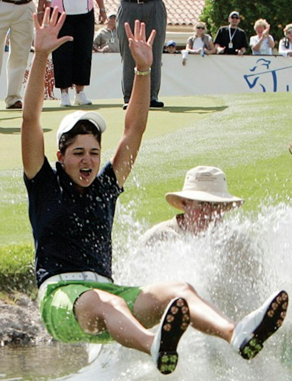 ** FILE ** This April 6, 2008 file photo shows Lorena Ochoa of Mexico, left, plunging into the lake alongside the 18th green after her victory in the LPGA Kraft Nabisco Championship golf tournament at Mission Hills Country Club in Rancho Mirage, Calif., in this April 6, 2008 file photo. Ochoa now has won four of five tournaments this year by a combined 34 shots, and goes for another victory this week at the Ginn Open.  (AP Photo/Reed Saxon, File)