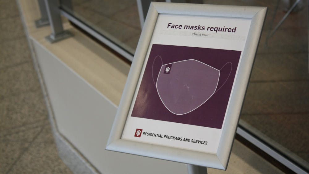 An Indiana University Residential Programs and Services sign requiring face masks is seen Feb. 24, 2022, in Read Hall. IU will lift mask mandate in classrooms, dining areas and other common areas March 4.