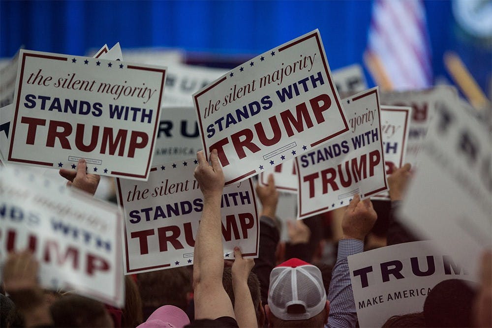 Supporters of presidential candidate Donald Trump hold signs up as Trump walks on stage to speak at a rally at the Kentucky International Convention Center in Louisville, Kentucky on Tuesday. 