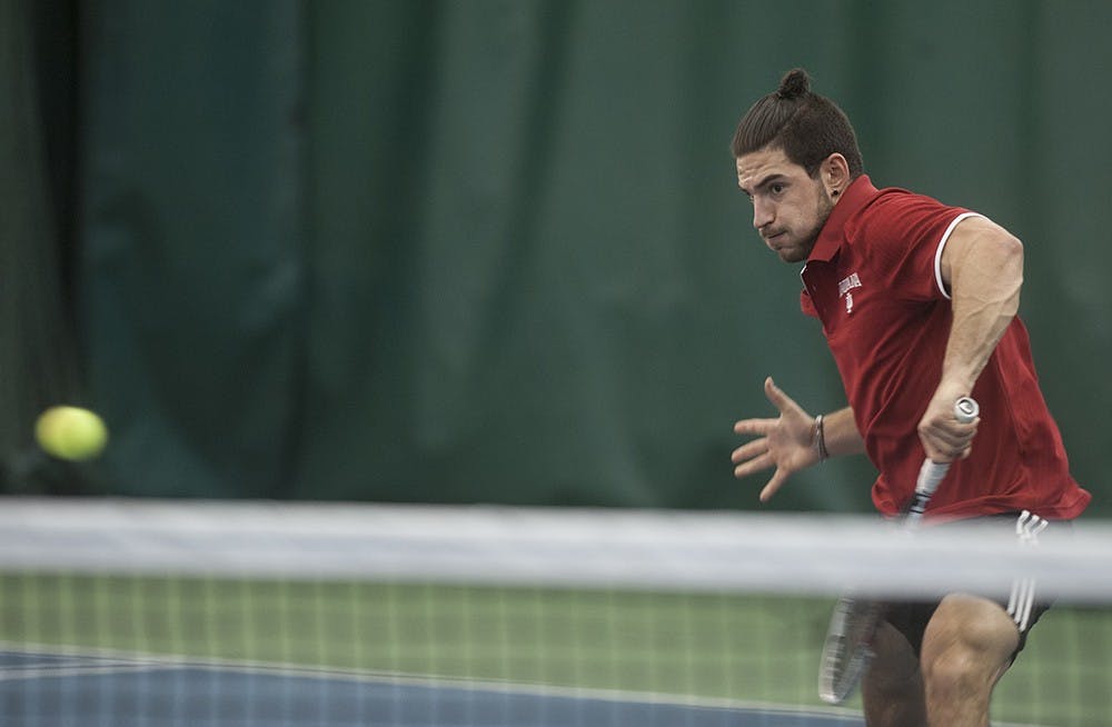 Sam Monette closing in to return with a volley against Sam Shropshire of Northwestern University on Friday at the IU Tennis Center. Monette lost the match 6-4, 7-5.