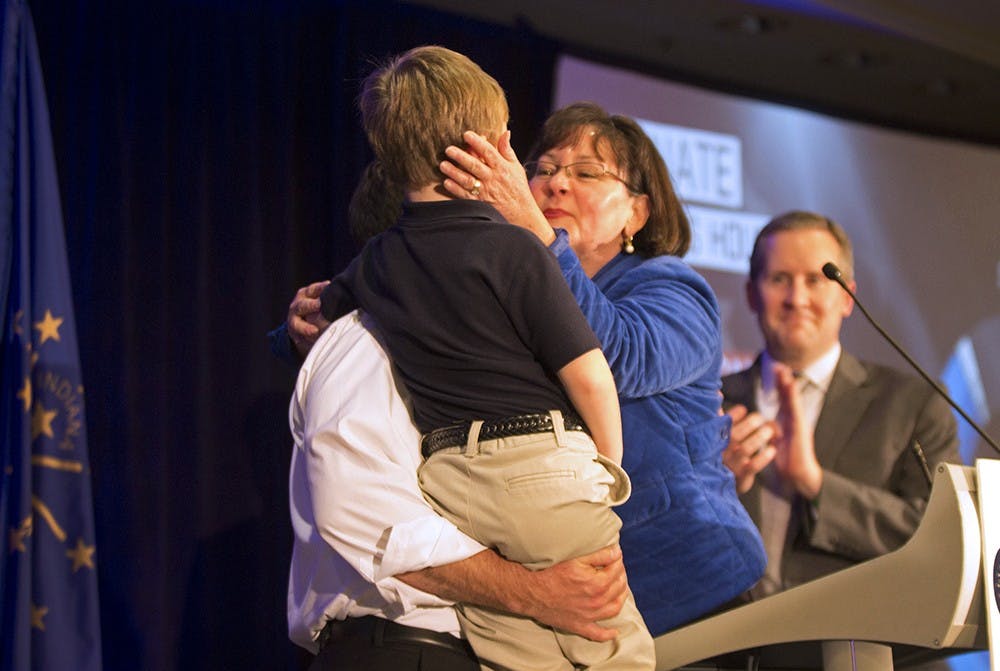 Secretary of state candidate Beth White embraces her husband Neil Marcus and her son Nathaniel after her campaign loss on Tuesday night in downtown Indianapolis.