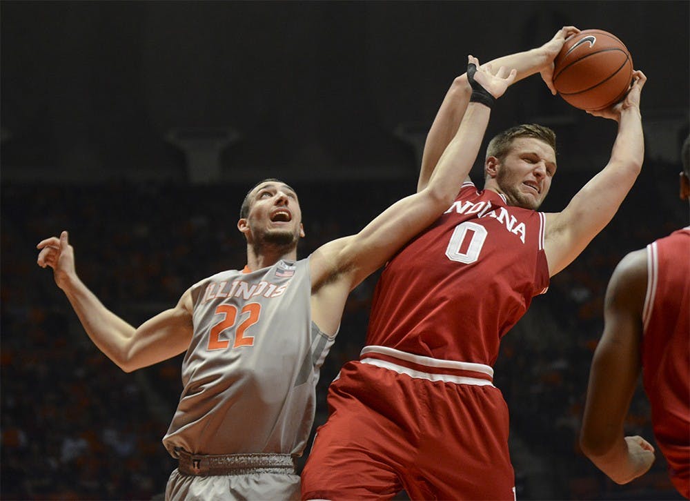 Senior forward Max Bielfeldt grabs a rebound over Illinois center Morgan Maverick Thursday at the State Farm Center in Champaign. The Hoosiers won 74-47. 