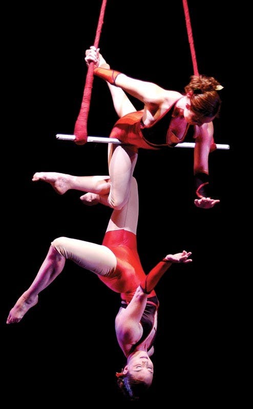 COURTESY PHOTOSerenity and Elsie Smith, members of the Colorful Hat Theatrical Circus, perform on the rotating Double Trapeze in this undated photo. The group will be appearing Wednesday, July 24th at the Buskirk-Chumley Theatre.