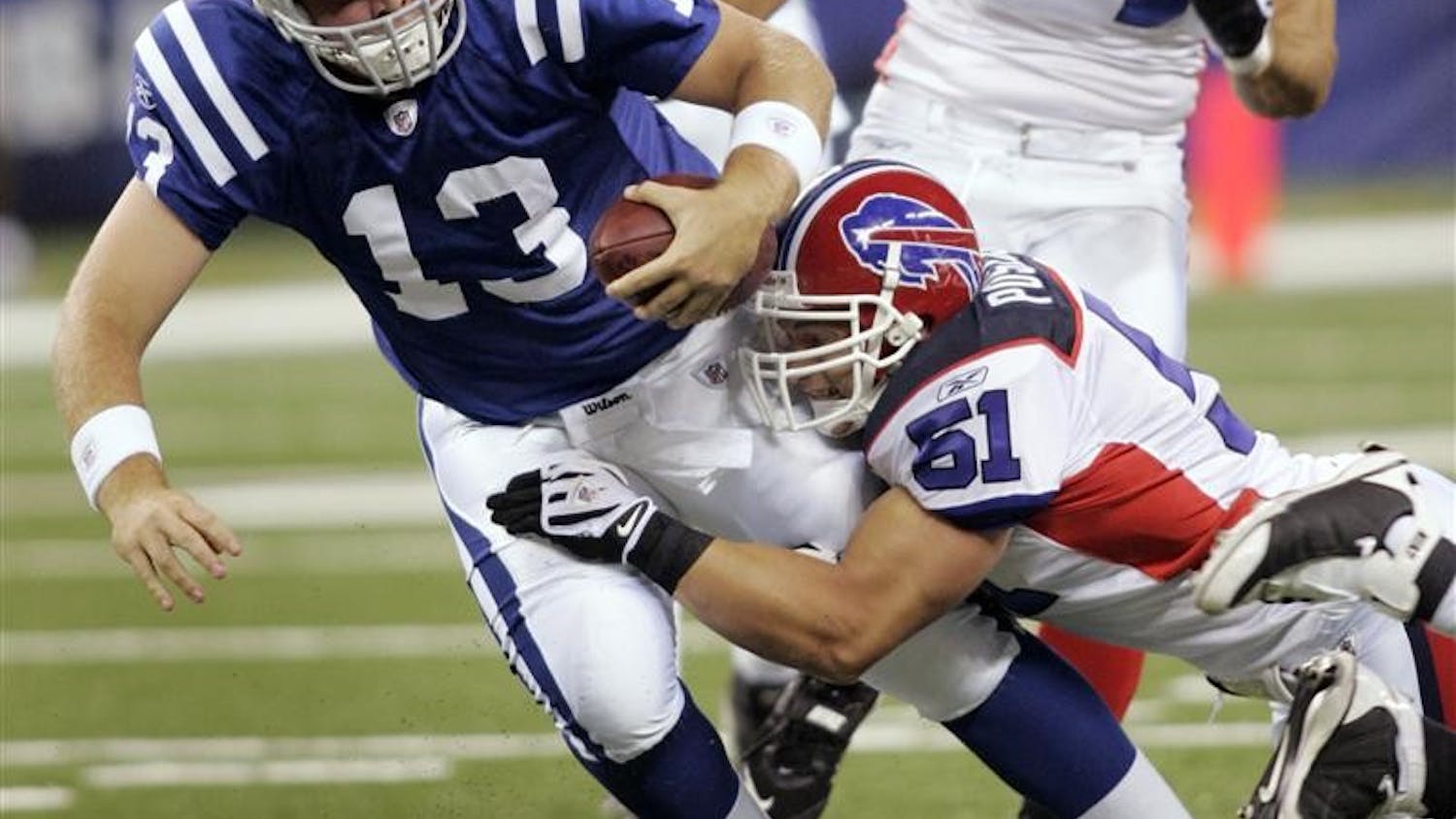 Indianapolis Colts quarterback Jared Lorenzen (13) is tackled by Buffalo Bills linebacker Paul Posluszny (51) during the first quarter of a preseason NFL football game Sunday in Indianapolis. The game is the Colts' first in the new Lucas Oil Stadium.