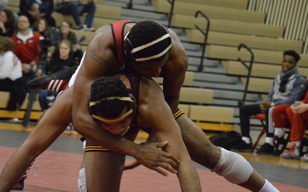 Senior Nate Jackson takes down Minnesota's Robert Stevenson in January in University Gym. Jackson placed eighth at the NCAA Championships and grabbed his second All-America honor this weekend.