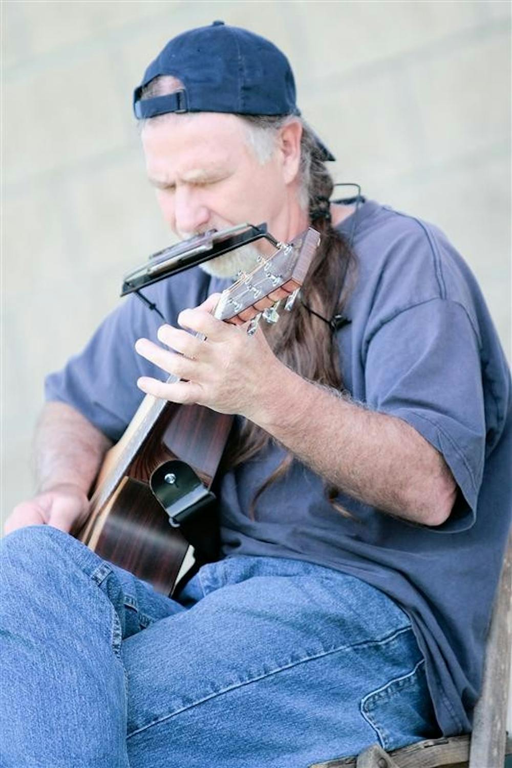 Singer-songwriter Marc Haggerty plays at a jam session Sunday at the Third Street Park. Haggerty, along with other musicians, hosted a reunion concert Saturday.