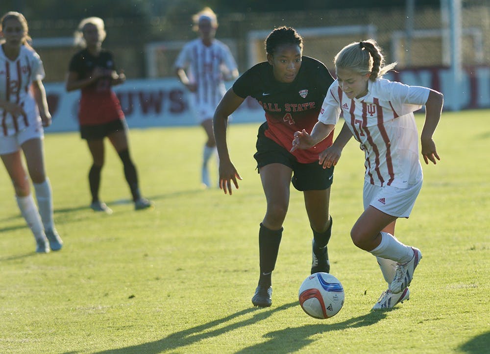 Sophomore midfielder Kayla Smith holds off a Ball State University Cardinals' defender at Bill Armstrong stadium on Sunday evening. IU tied the game 1-1.