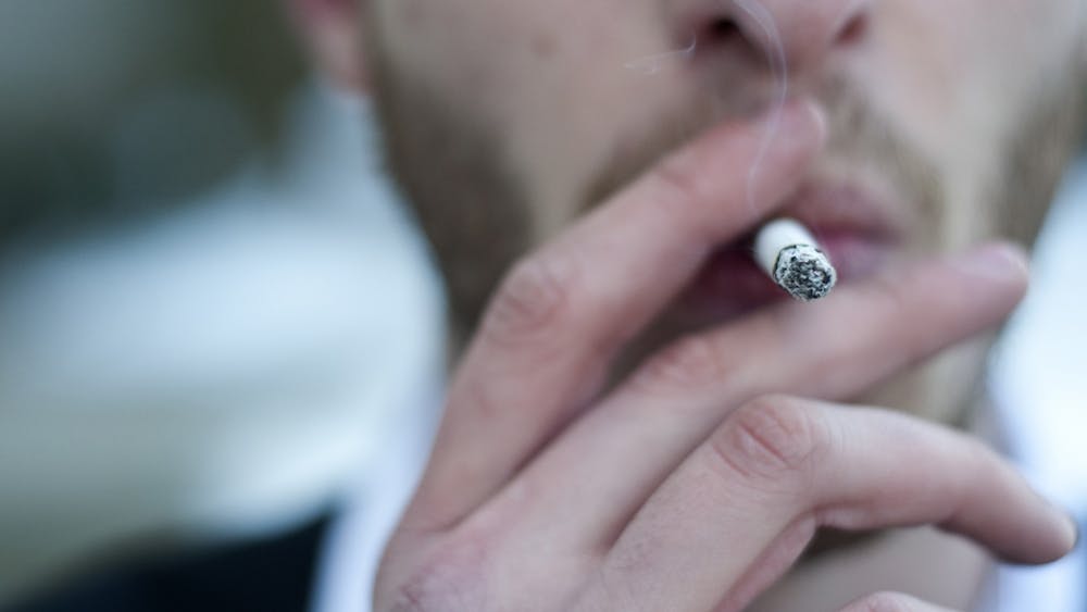 A man smokes a cigarette. Recent results from the 2022 Indiana Youth Survey show some of the most significant decreases in substance use among Indiana youth in more than 30 years, IU News reported. 