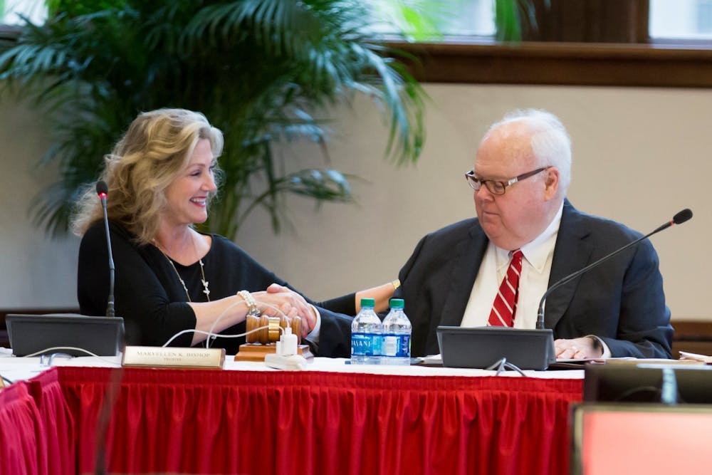 <p>Trustees MaryEllen Bishop and James Morris shake hands July 2019 at an IU Board of Trustees meeting. Morris retired from his position after more than two decades of service.</p>