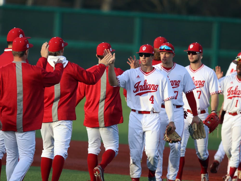 The IU baseball team high-fives March 4, 2022, at Bart Kaufman Field. Indiana lost in the first round of the Big Ten Tournament on Thursday evening, meaning the team will enter the losers’ bracket and will play in an elimination game Friday afternoon.