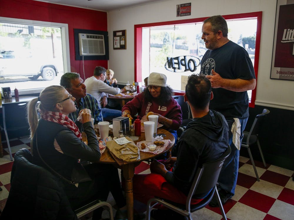 Richie jokes with the Morning family, first-time customers at Hinkle’s, about the size of the store’s pork tenderloin. Richie himself was far from a first-time customer when he purchased the restaurant, having frequented the shop with his family since he was young. 