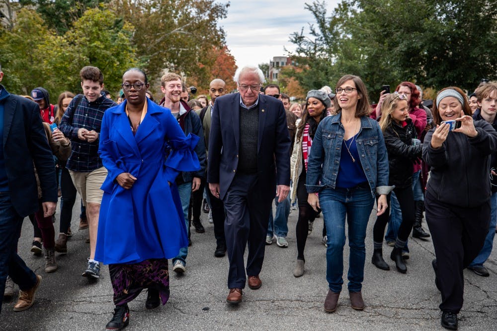 <p>Sen. Bernie Sanders, I-Vermont, center, walks with Liz Watson, center right, down Indiana Avenue to lead a group of people to a voting center in Bloomington on Oct. 19 after Sanders and Watson spoke at a rally at Dunn Meadow.</p>
