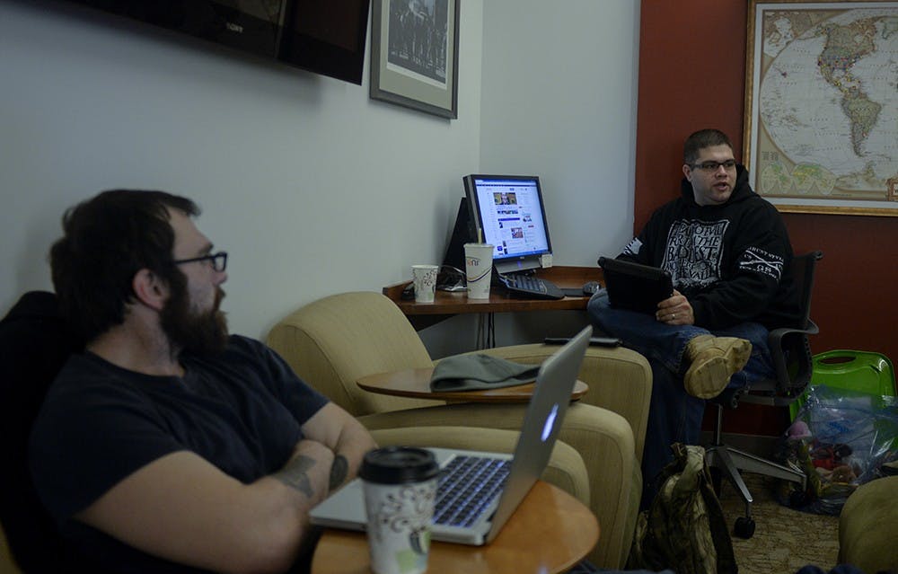 David Mathews (left) and Josh Garrison Talk with Macabee during their lunch at the Veterans Support Services center. Mathews, a religious studies major and navy veteran, eats lunch and talks with Macabee almost every day of the week. 