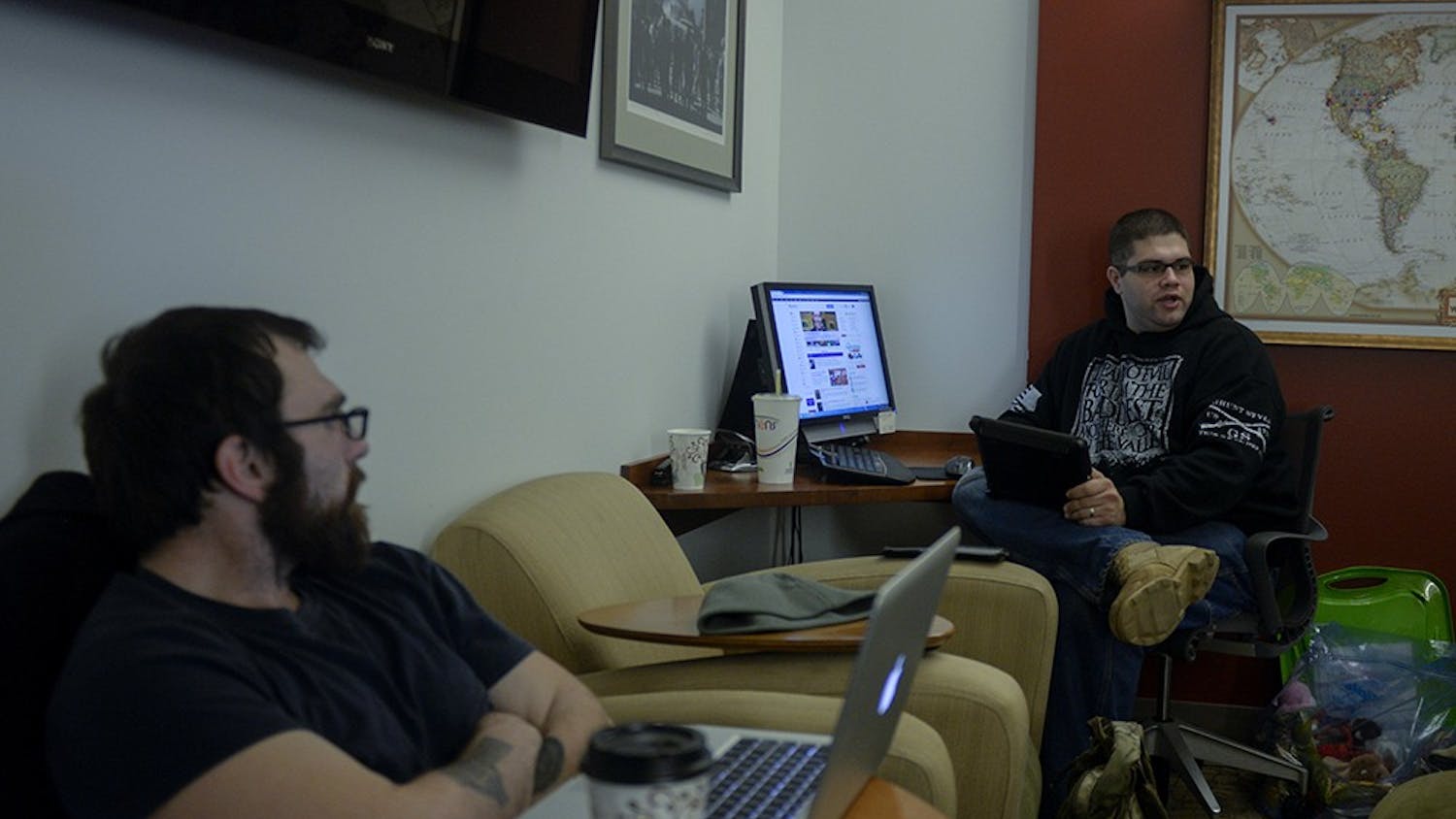 David Mathews (left) and Josh Garrison Talk with Macabee during their lunch at the Veterans Support Services center. Mathews, a religious studies major and navy veteran, eats lunch and talks with Macabee almost every day of the week.
