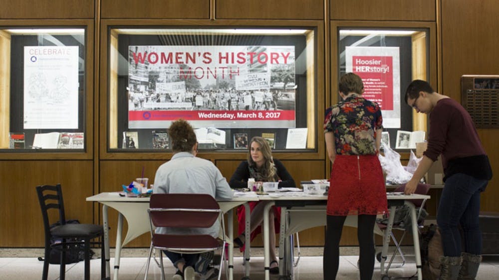 Students and faculty gather in celebration of International Womens Day Wednesday afternoon in the Herman B Wells Library lobby.