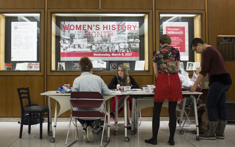 Students and faculty gather in celebration of International Womens Day Wednesday afternoon in the Herman B Wells Library lobby. 
