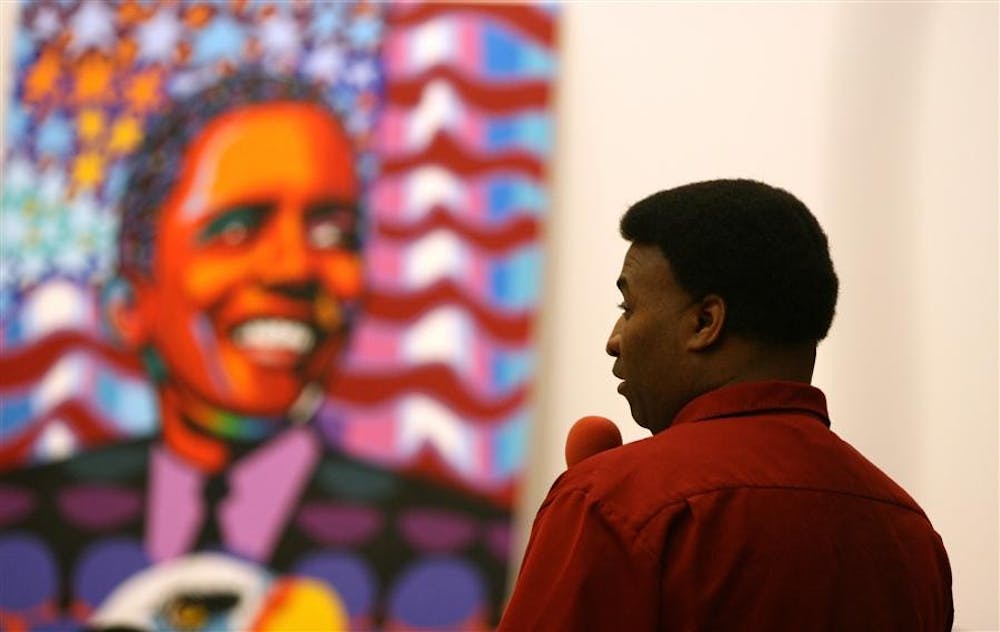 Joel Washington speaks about his painting, which is "a work in progress" at The Black History Art Fair Feb. 10 in the Neal Marshall Black Culture Center. Washington was the featured artist at the event.