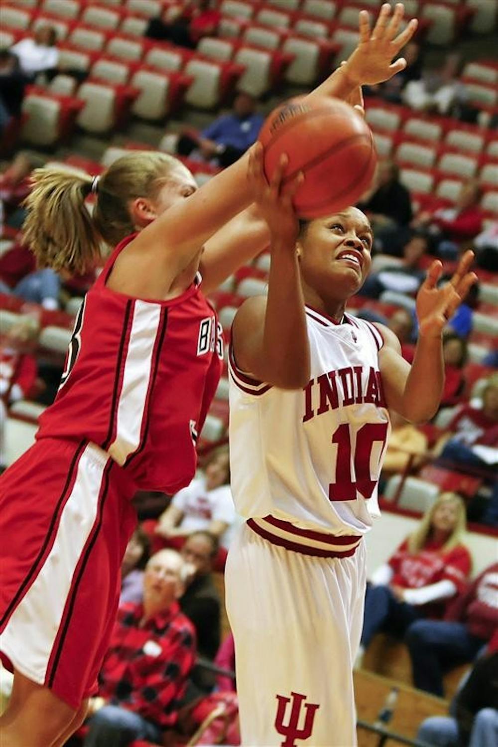 Sophomore guard Andrea McGuirt attempts a layup under the outstretched arms of a Ball State defender during the Hooisers 84-68 win over the Cardinals Nov. 14th at Assembly Hall. 