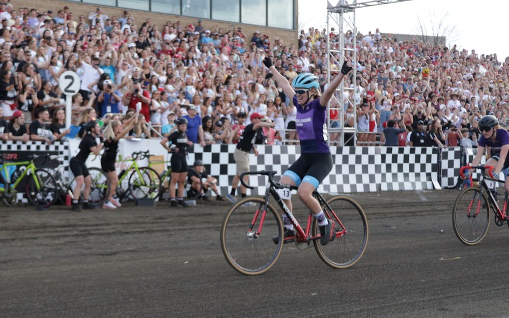 <p>A rider for Melanzana crosses the Little 500 finish line April 22, 2022, at Bill Armstrong Stadium. Melanzana took first, for the first time ever, in the Women&#x27;s Little 500. </p>