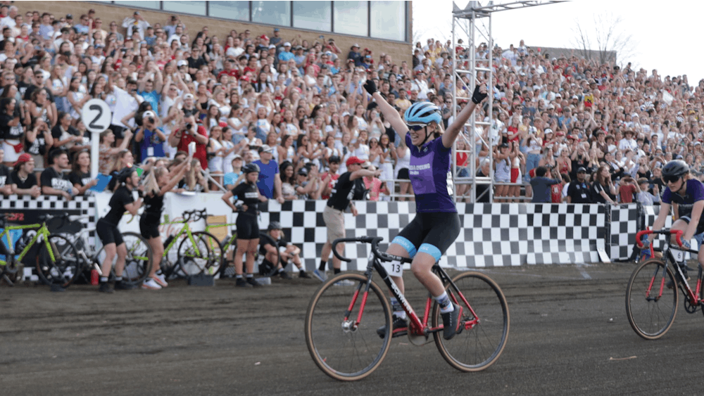 A rider for Melanzana crosses the Little 500 finish line April 22, 2022, at Bill Armstrong Stadium. Melanzana took first, for the first time ever, in the Women&#x27;s Little 500. 