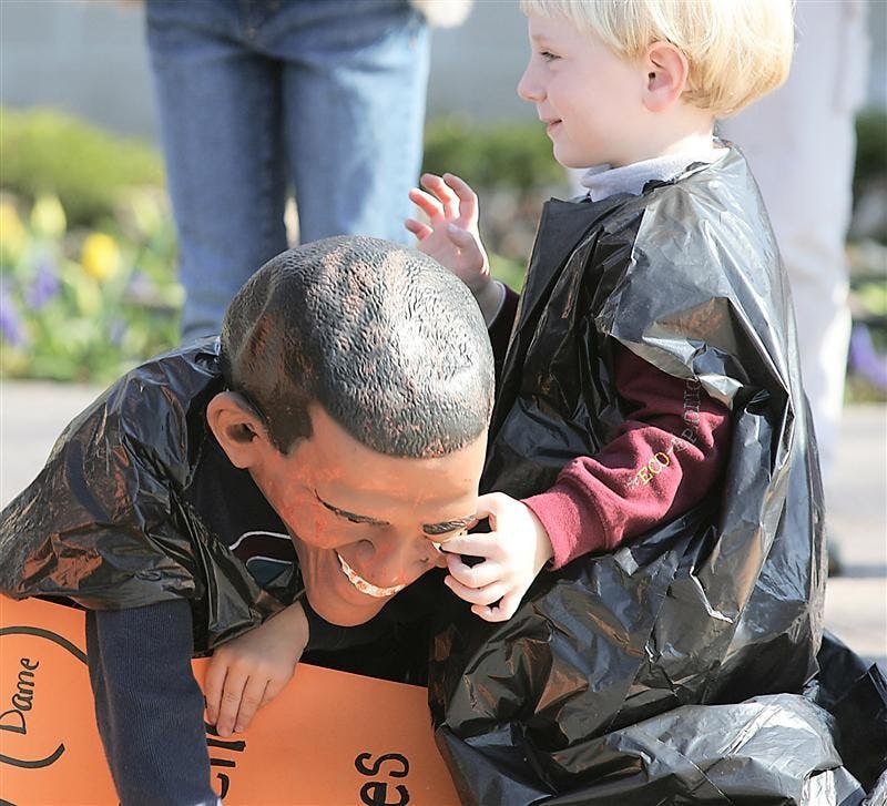 While wearing a President Obama mask, Michael Terry, left, of Falls Church, Va., attracts some attention from a fellow protester during an anti-abortion protest Friday April 17, 2009 at the main gate of the University of Notre Dame in South Bend, Ind.