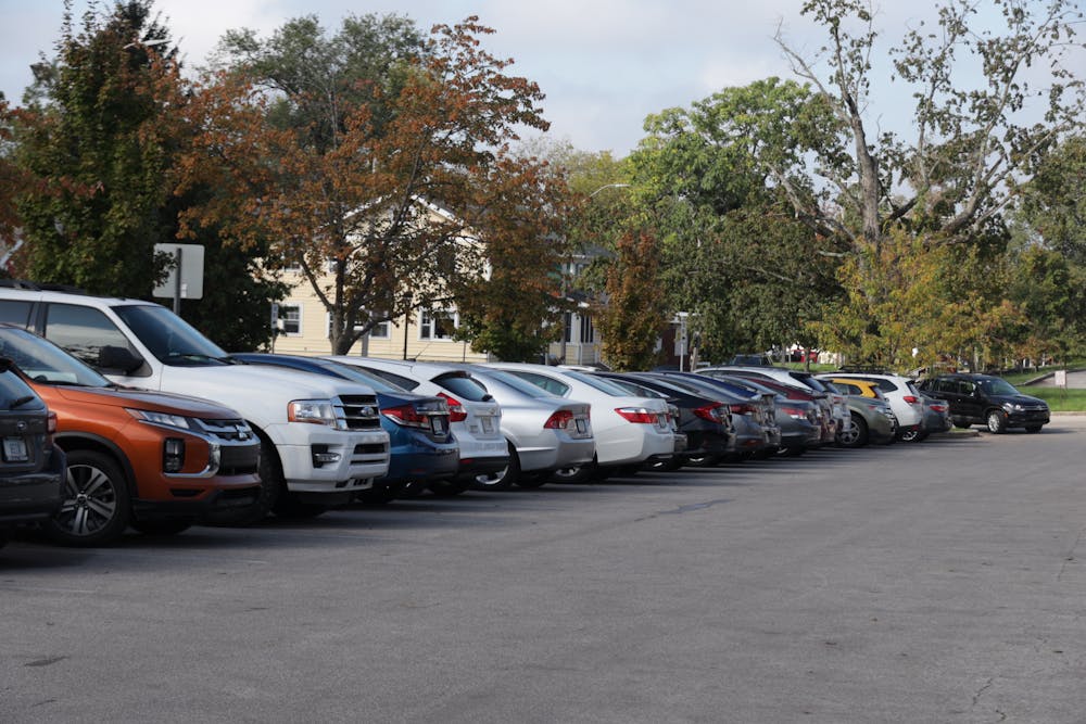 <p>Cars are seen parked Oct. 5, 2021, in the parking lot on the corner of Atwater Ave. and S. Woodlawn Ave. IU students have begun to get involved with local government to fight against predatory towing practices in Bloomington.</p>