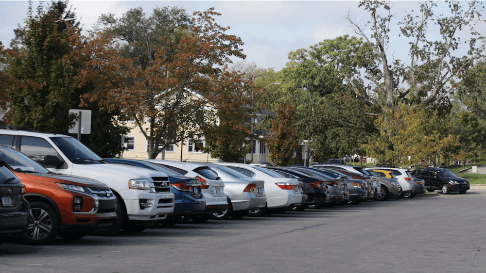 Cars are seen parked in an EM-P parking zone Dec. 1, 2022, in a lot at the corner of Indiana Avenue and S﻿ixth Street. IU students have begun to get involved with local government to fight against predatory towing practices in Bloomington.