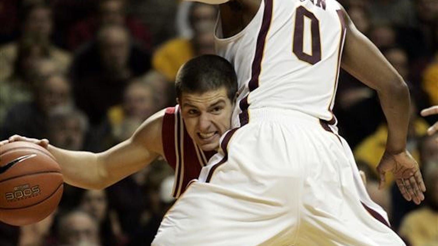 Indiana guard Daniel Moore (3) drives under the basket against Minnesota guard Al Nolen (0) during the first half Tuesday in Minneapolis.