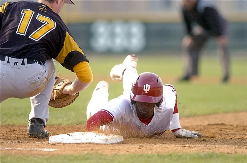 Junior outfielder Evan Crawford dives back to first base after Valparaiso's Ryan O'Gara tries to apply a tag on a pickoff play. Crawford had two hits in the 9-5 Hoosier win.