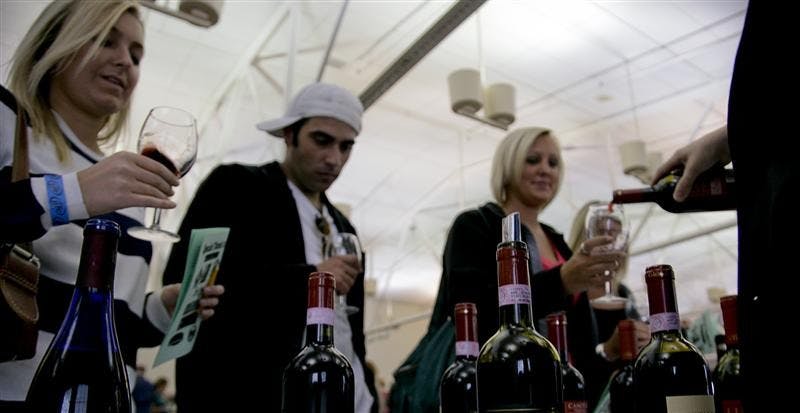 Seniors Kelsey Walker, John Wright and McKenzie Breedlove sample wine Friday evening at the Bloomington Convention Center. Along with their friend senior Mallory Hobbs, this was their first wine festival, and they sampled many various types of wine from multiple vendors from across the state.
