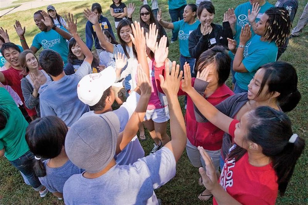 Students "high five" during the Asian Cultural Center's annual Student Leadership Retreat Saturday morning outside Read Quad.