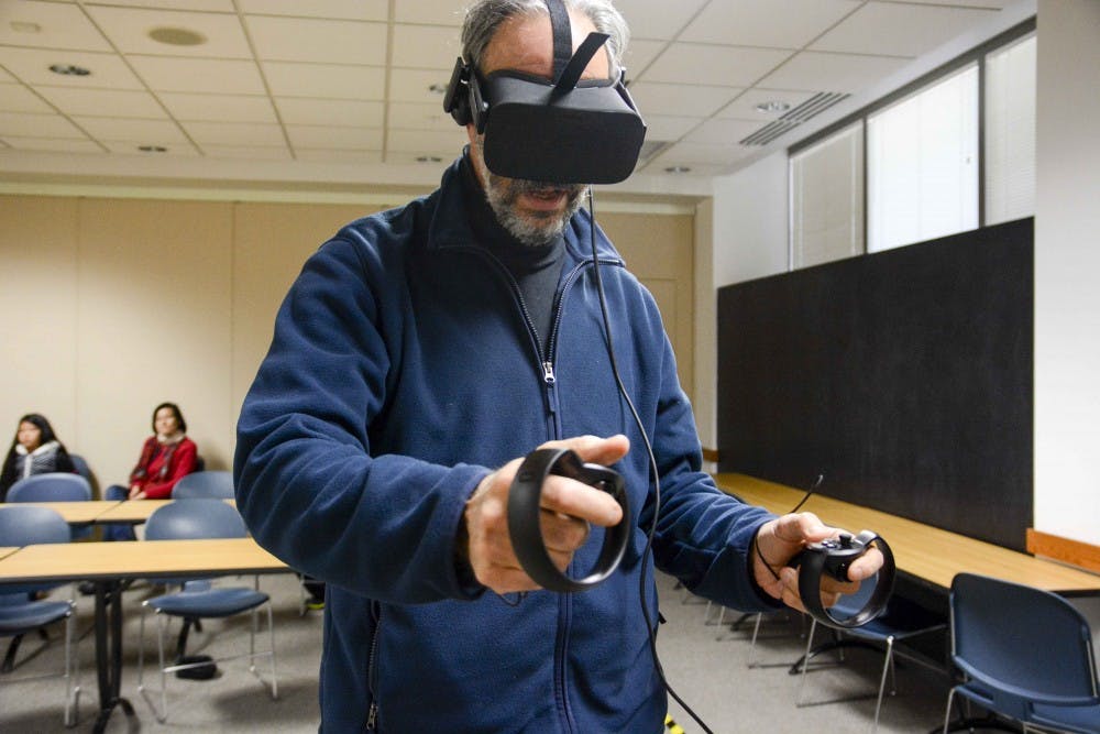 Lweis Rifkowitz, an artist, draws in a three dimensional room with virtual reality headsets named Rift Oculus on Sunday at Monroe Country Public Library. "I love It!" Rifkowitz said.