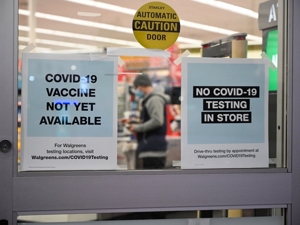 A sign on the entrance to a pharmacy reads &quot;COVID-19 Vaccine Not Yet Available,&quot; Nov. 23 in Burbank, California. Moderna Inc. plans to request clearance for its coronavirus vaccine in the U.S. and Europe this month.
