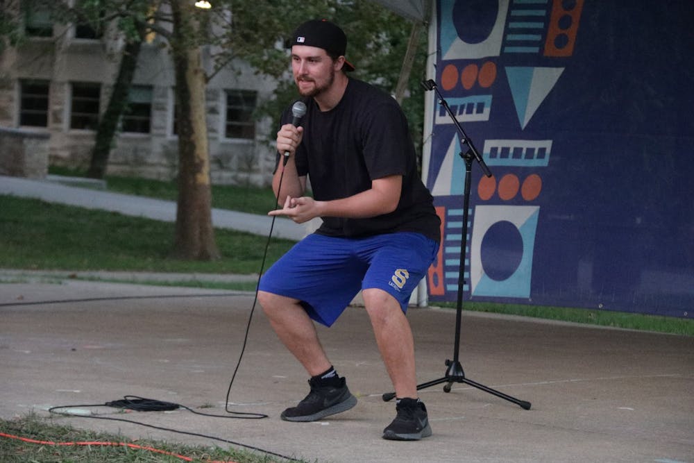 <p>IU junior James Vogt gives a set during a comedy open mic night Sept. 27, 2021, in Dunn Meadow. Vogt was one of two student comedians who performed. </p>
