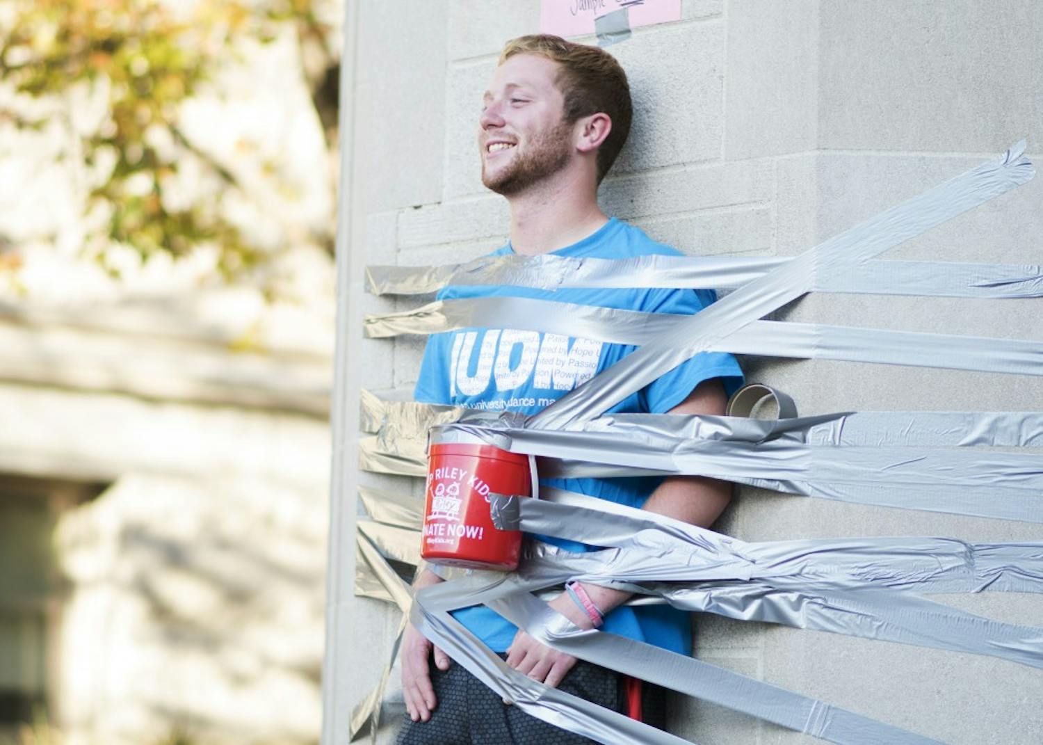 Isaac Peasley, a junior, tapes himself to the Sample Gates for IU Dance Marathon's Day of Hope. Peasely, who has participated in six dance marathons, said he started getting involved with the event when a close friend received medical treatment from Riley Hospital for Children in Indianapolis.&nbsp;