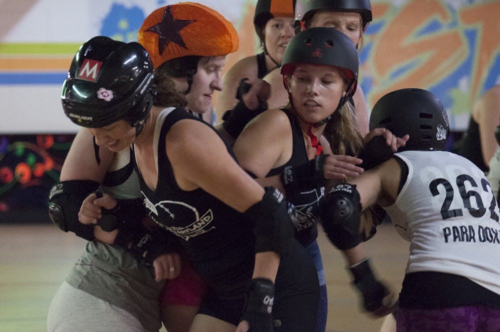 Skaters demonstrate the game of roller derby at Bleeding Heartland Roller Derby's skills camp on Monday.