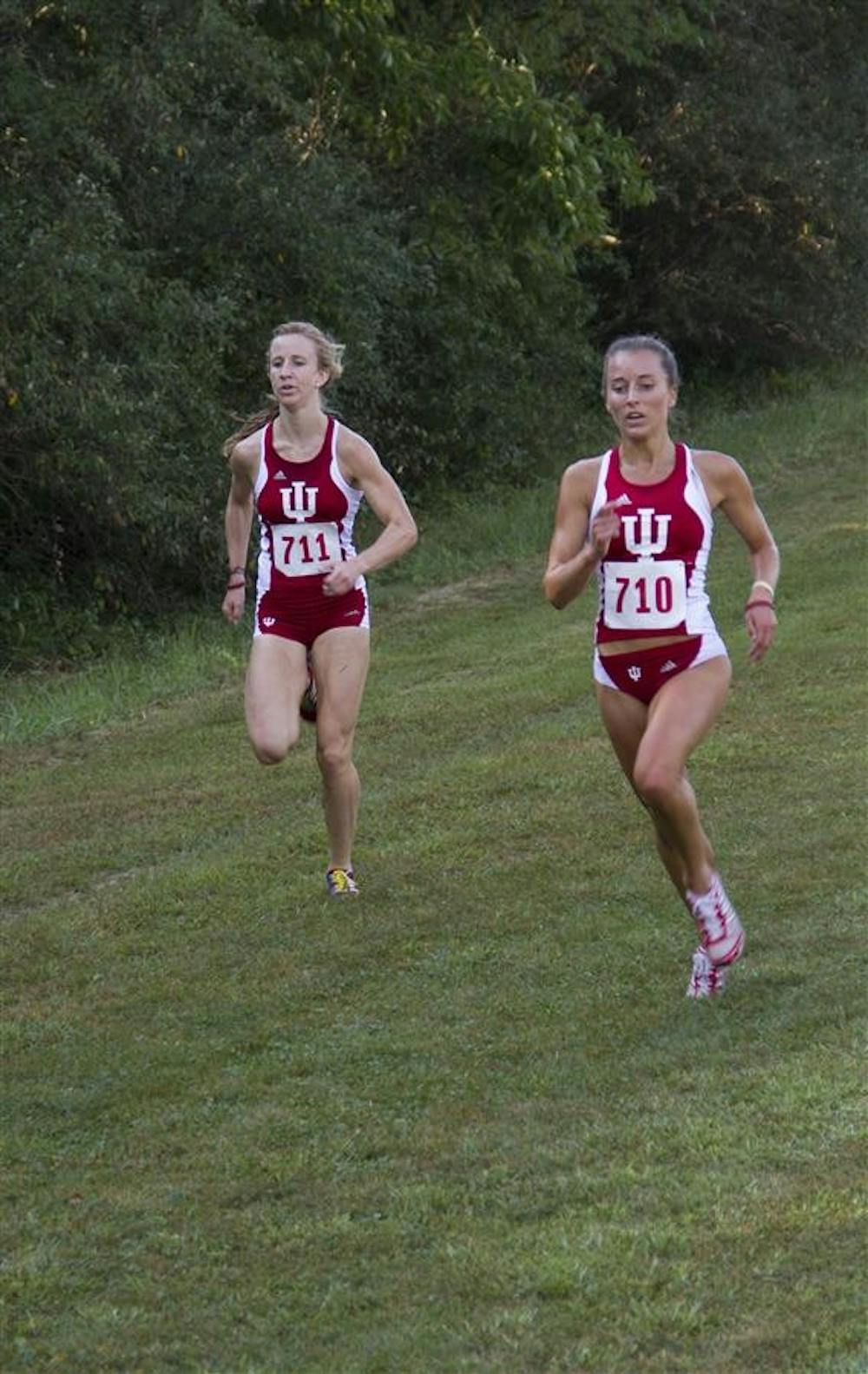Senior Samantha Ginther runs with junior Kelsey Duerksen during the Indiana Open on Sept. 7 at the IU Cross Country Course. Ginther finished second in the race.