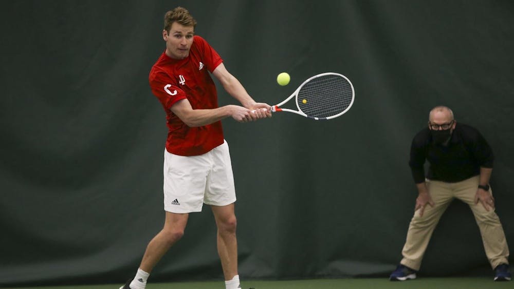 IU graduate student Bennett Crane swings his racket in a game against Michigan on April 3. Crane was named First Team All-Big Ten last Tuesday.