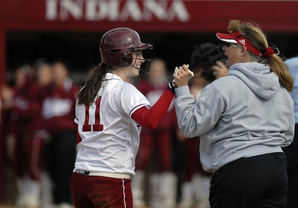 IU utility player Bridget Langan high-fives head coach Michelle Garnder after hitting a triple in the second inning Wednesday during the second game of a double header. Langan's hit kicked off a four run inning to propel the Hoosiers to a 8-0 win over Ball State after defeating the Cardinals 2-1 in the first game. 